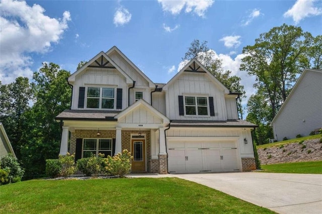 craftsman inspired home with a garage and a front lawn