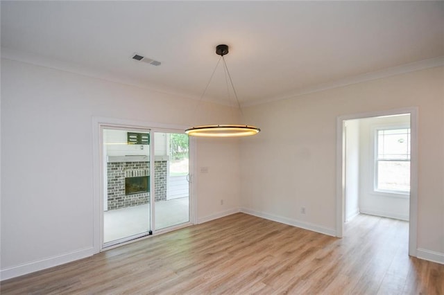 5354 Shadow Walk Way, Gainesville, GA 30507 - empty room with light wood finished floors, crown molding, baseboards, and a brick fireplace