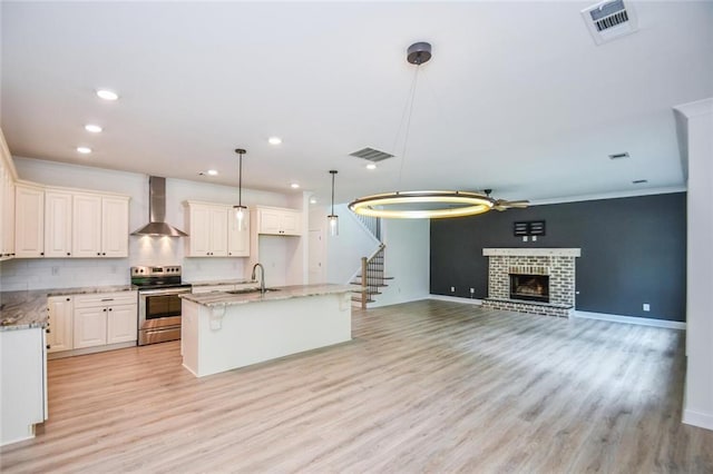 5354 Shadow Walk Way, Gainesville, GA 30507 - kitchen with stainless steel electric range, wall chimney exhaust hood, a sink, light stone counters, and recessed lighting