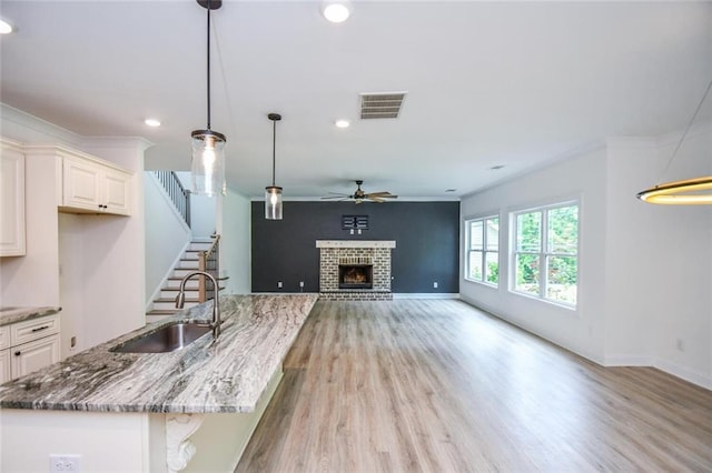 5354 Shadow Walk Way, Gainesville, GA 30507 - kitchen with a sink, a ceiling fan, light wood-style flooring, stone counters, and recessed lighting