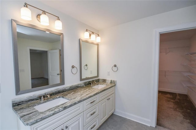 5354 Shadow Walk Way, Gainesville, GA 30507 - bathroom featuring double vanity, a spacious closet, and baseboards