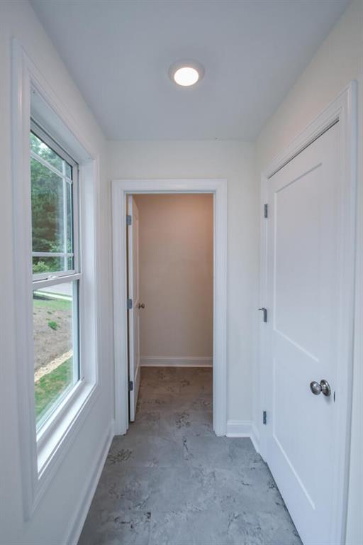 5354 Shadow Walk Way, Gainesville, GA 30507 - hallway with unfinished concrete flooring and baseboards