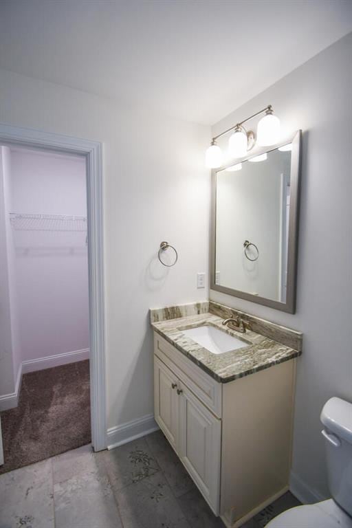 5354 Shadow Walk Way, Gainesville, GA 30507 - bathroom with vanity, baseboards, toilet, and a walk in closet