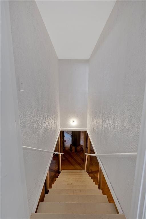 stairway featuring wood-type flooring