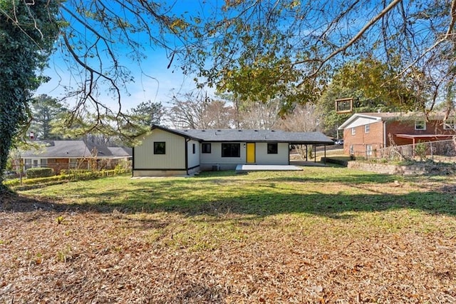 rear view of property with a yard