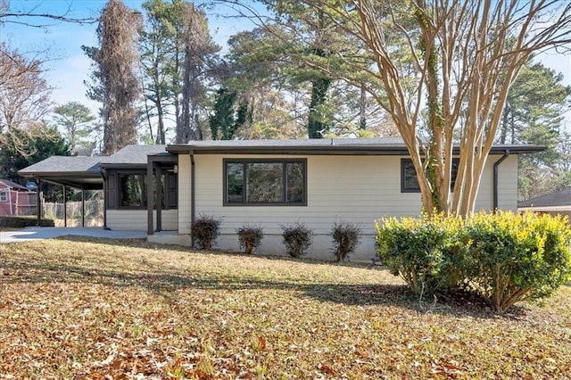 view of front of house with a front lawn and a carport