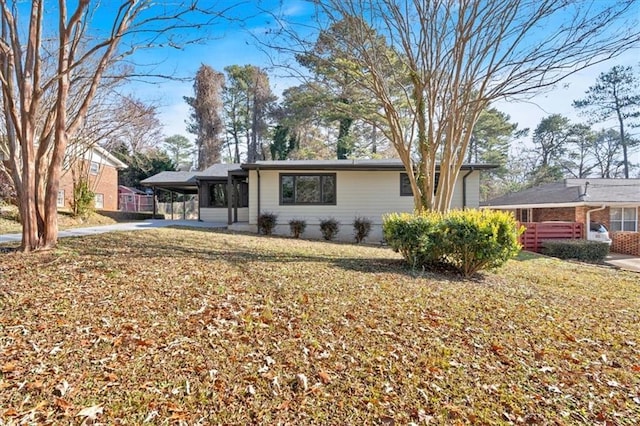 view of front of property with a front lawn and a carport