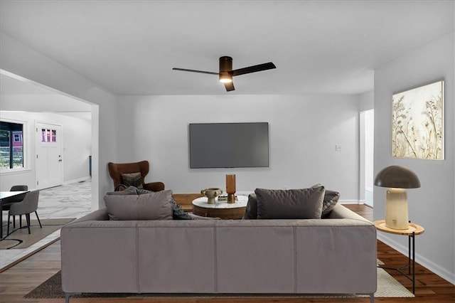 living room with hardwood / wood-style flooring and ceiling fan