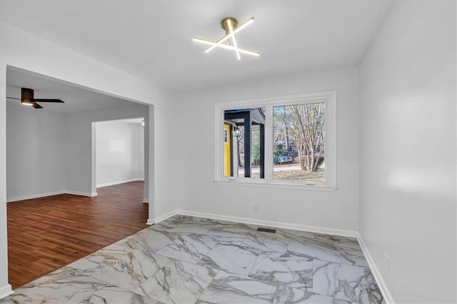 empty room featuring ceiling fan and hardwood / wood-style floors