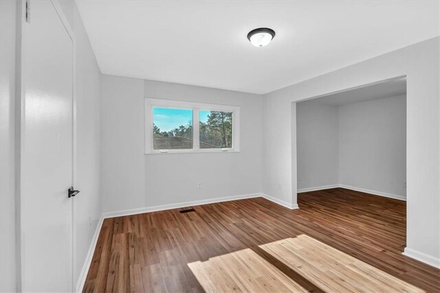 empty room featuring hardwood / wood-style flooring