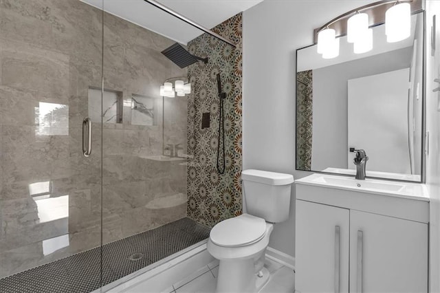 bathroom featuring tile patterned floors, vanity, toilet, and walk in shower