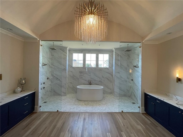 bathroom with vaulted ceiling, hardwood / wood-style floors, and plus walk in shower