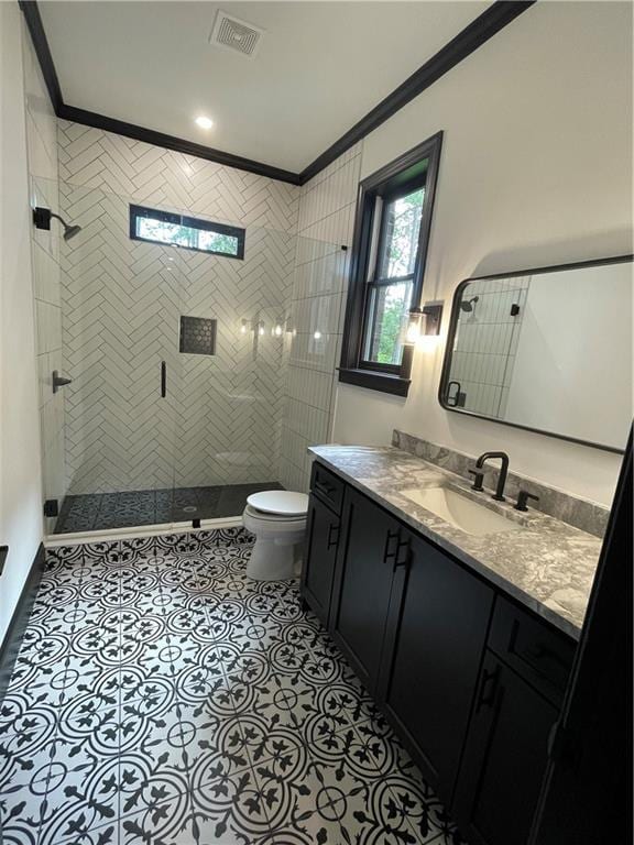 bathroom featuring ornamental molding, vanity, tile patterned floors, and toilet