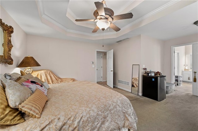 carpeted bedroom with stainless steel fridge, a raised ceiling, ceiling fan, and crown molding