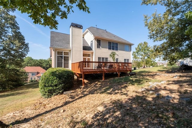 rear view of property with a yard and a deck