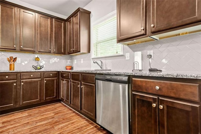 kitchen with tasteful backsplash, dishwasher, and dark brown cabinetry