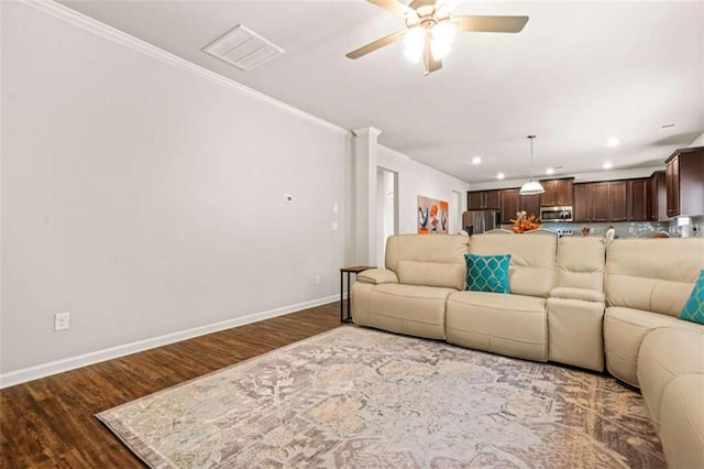 living area featuring visible vents, ceiling fan, wood finished floors, and baseboards