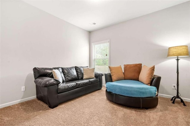 living area with visible vents, carpet flooring, and baseboards