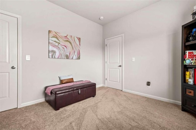 living area with baseboards and carpet