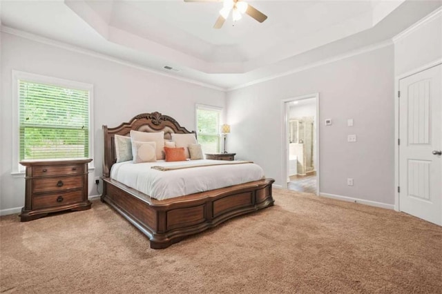 bedroom featuring a raised ceiling, crown molding, a ceiling fan, visible vents, and carpet floors