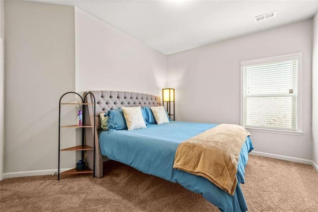 bedroom featuring baseboards, visible vents, and carpet flooring