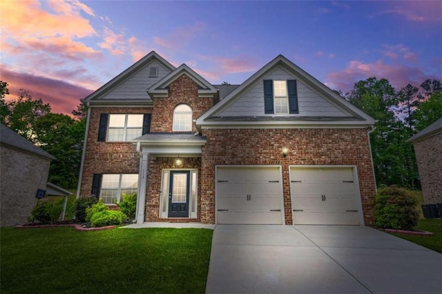 traditional-style house with brick siding, a front yard, and concrete driveway