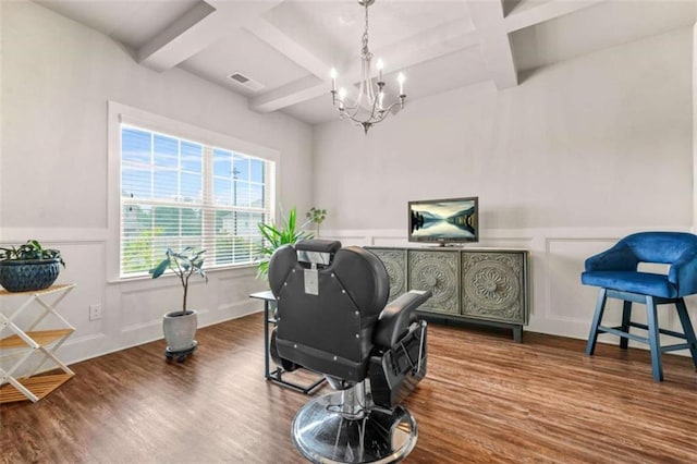 home office with a chandelier, visible vents, a decorative wall, coffered ceiling, and wood finished floors