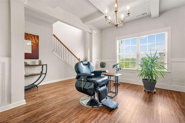 living area featuring beamed ceiling, a notable chandelier, visible vents, and wood finished floors