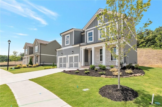 craftsman inspired home with a garage and a front yard