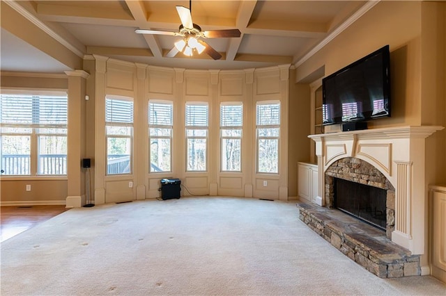 interior space featuring carpet, a fireplace, ceiling fan, coffered ceiling, and beamed ceiling