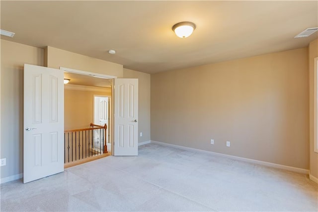 unfurnished room with light carpet