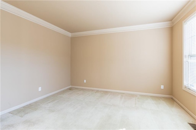 empty room with ornamental molding and light carpet