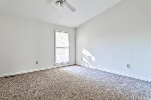 carpeted empty room featuring lofted ceiling and ceiling fan