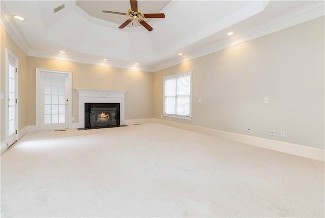 unfurnished living room featuring light carpet, crown molding, and a raised ceiling