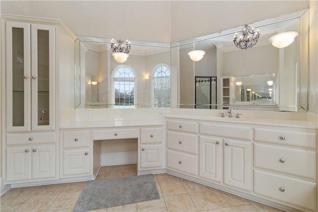 bathroom featuring crown molding, a chandelier, tile patterned floors, and vanity