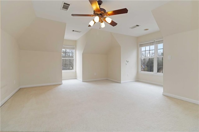 additional living space with light carpet, lofted ceiling, and ceiling fan