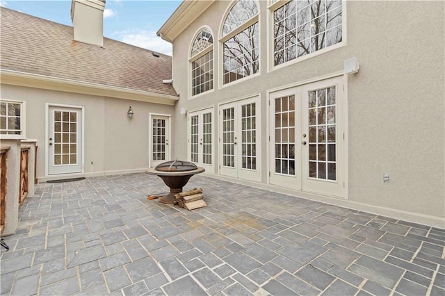 view of patio with french doors and a fire pit