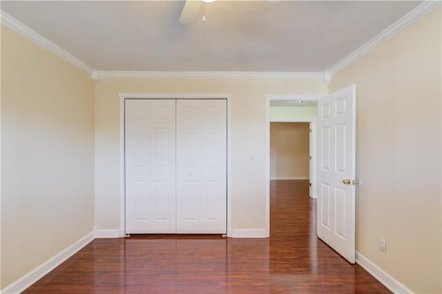 unfurnished bedroom featuring dark wood-style floors, crown molding, and baseboards