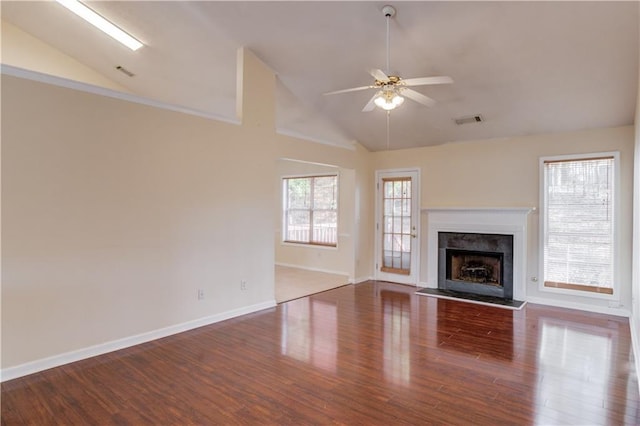 unfurnished living room with visible vents, a ceiling fan, lofted ceiling, dark wood-style floors, and a premium fireplace