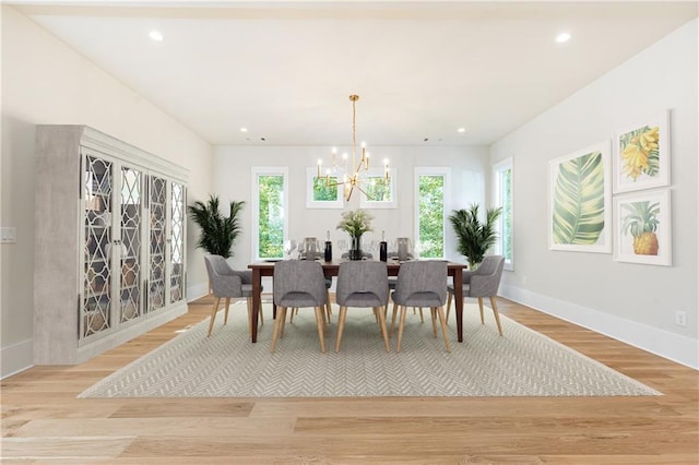 dining room featuring an inviting chandelier, a wealth of natural light, and light wood-type flooring