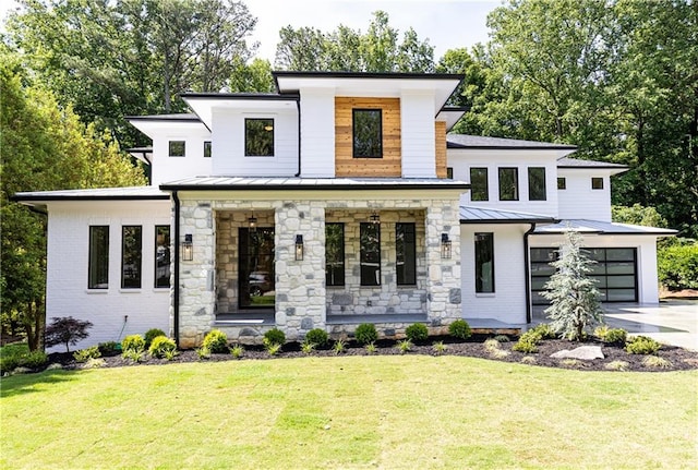 view of front of property featuring a garage and a front yard