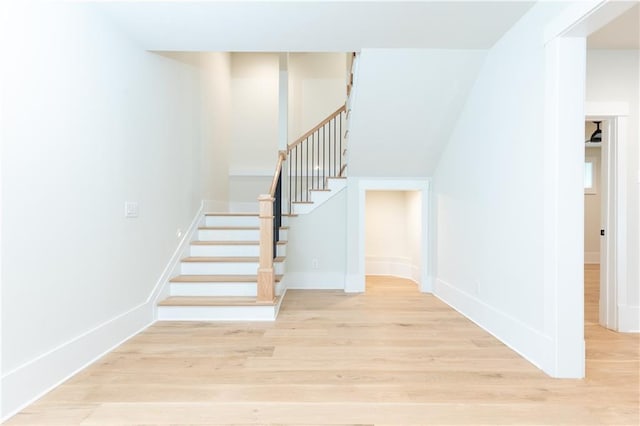 stairway with hardwood / wood-style flooring