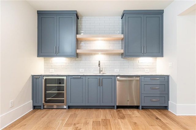 kitchen with dishwasher, blue cabinetry, wine cooler, and decorative backsplash