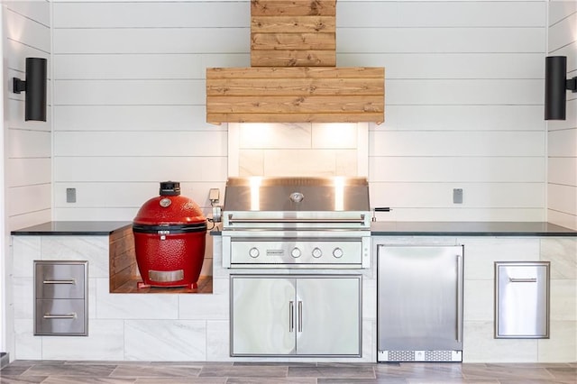 kitchen featuring wooden walls and built in refrigerator