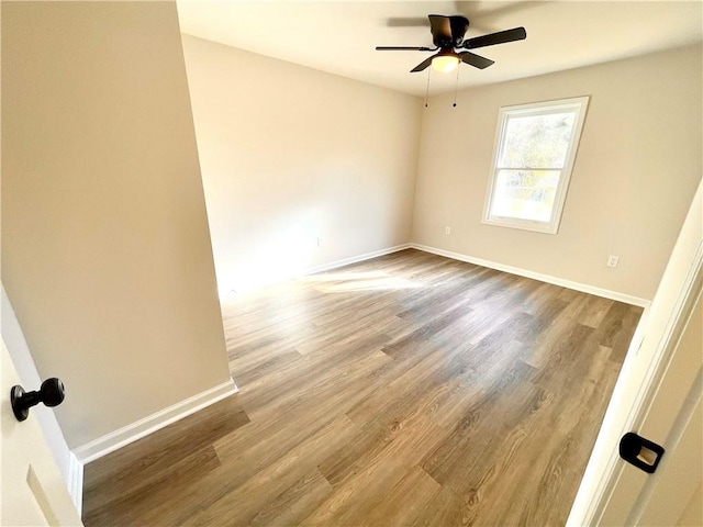 spare room with hardwood / wood-style floors and ceiling fan