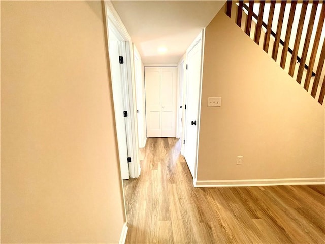 corridor with light wood-type flooring