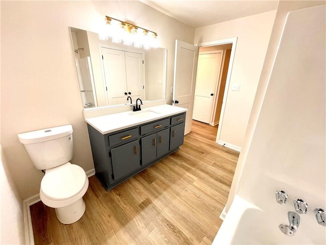 full bathroom with toilet, vanity, tub / shower combination, and hardwood / wood-style flooring