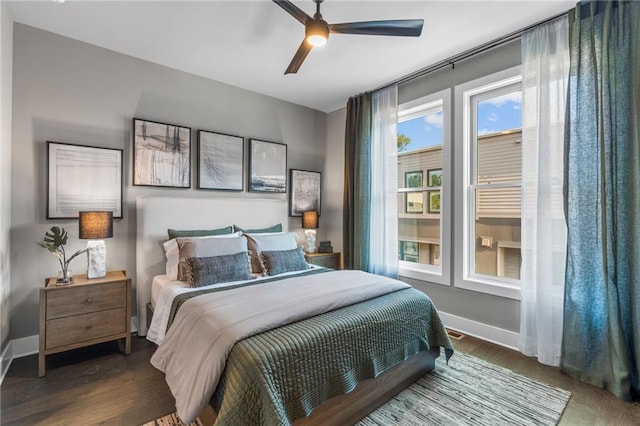 bedroom with ceiling fan and dark hardwood / wood-style floors