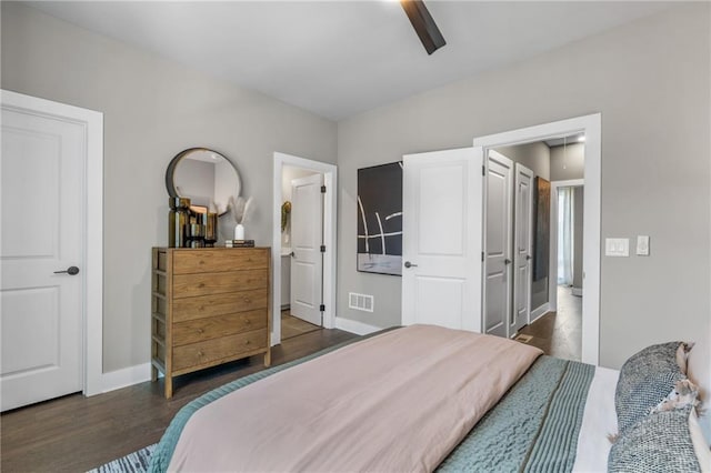 bedroom with dark hardwood / wood-style floors and ceiling fan