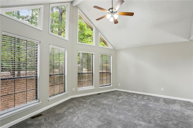 unfurnished sunroom featuring lofted ceiling with beams, ceiling fan, and a healthy amount of sunlight